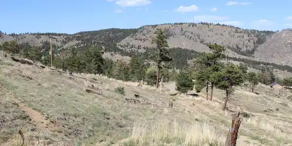 Image 2: northern view of Lee Hill and subject property down to Co Rd 85 and Sunshine Canyon Drive