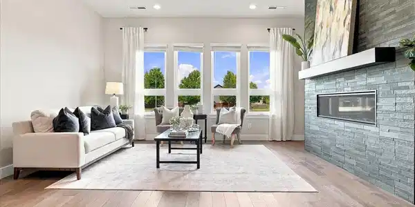 Image 4: The great room features soaring natural light and a warm, inviting fireplace. Image 4: The great room features soaring natural light and a warm, inviting fireplace.