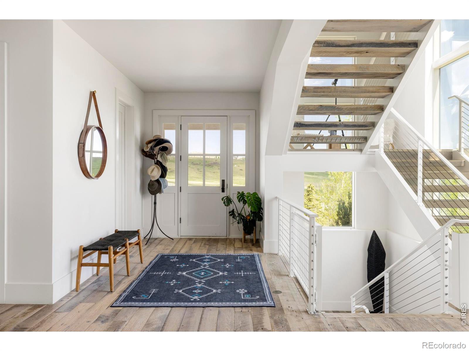 Image 4: Inside the main house, reclaimed hardwood floors and painted tongue-and-groove ceilings create a warm, natural aesthetic.