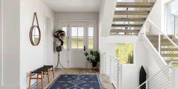 Image 4: Inside the main house, reclaimed hardwood floors and painted tongue-and-groove ceilings create a warm, natural aesthetic.
