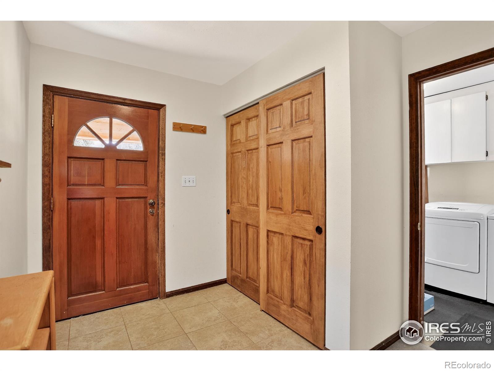 Image 4: Foyer with Washer/Dryer and a closet adjacent to front door Image 4: Foyer with Washer/Dryer and a closet adjacent to front door