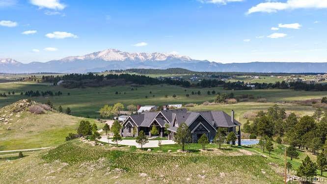 Image 1: Set on top of a hill to take in captivating mountain views