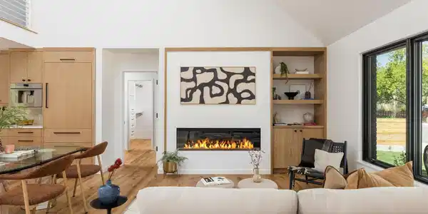 Image 3: Double-height ceilings, expansive windows, and a linear fireplace anchor the light-filled living room. Image 3: Double-height ceilings, expansive windows, and a linear fireplace anchor the light-filled living room.