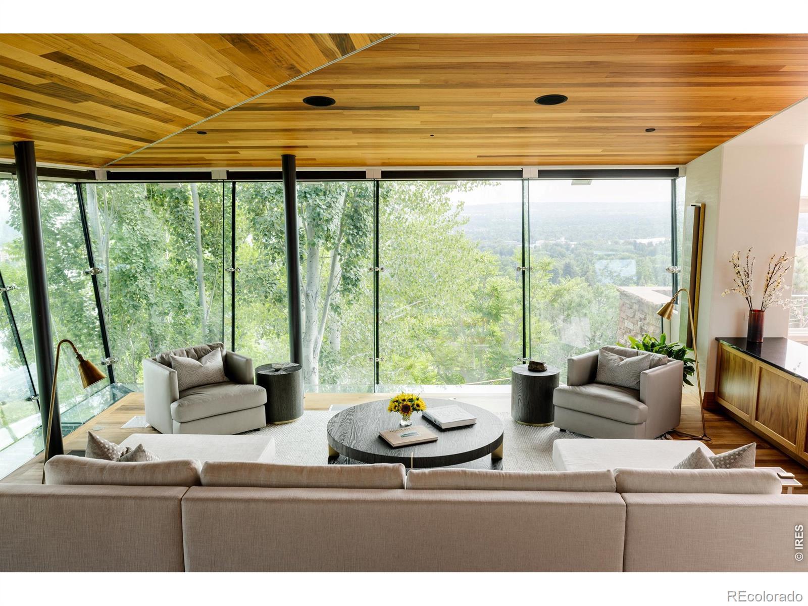 Image 2: Floor to ceiling windows wrap around the living room providing 180 degrees of views and mature aspens Image 2: Floor to ceiling windows wrap around the living room providing 180 degrees of views and mature aspens