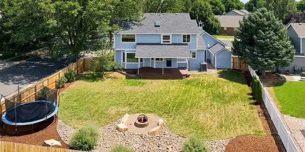 Image 3: Very spacious, landscaped backyard with fire pit and covered deck. Perfect for entertaining!