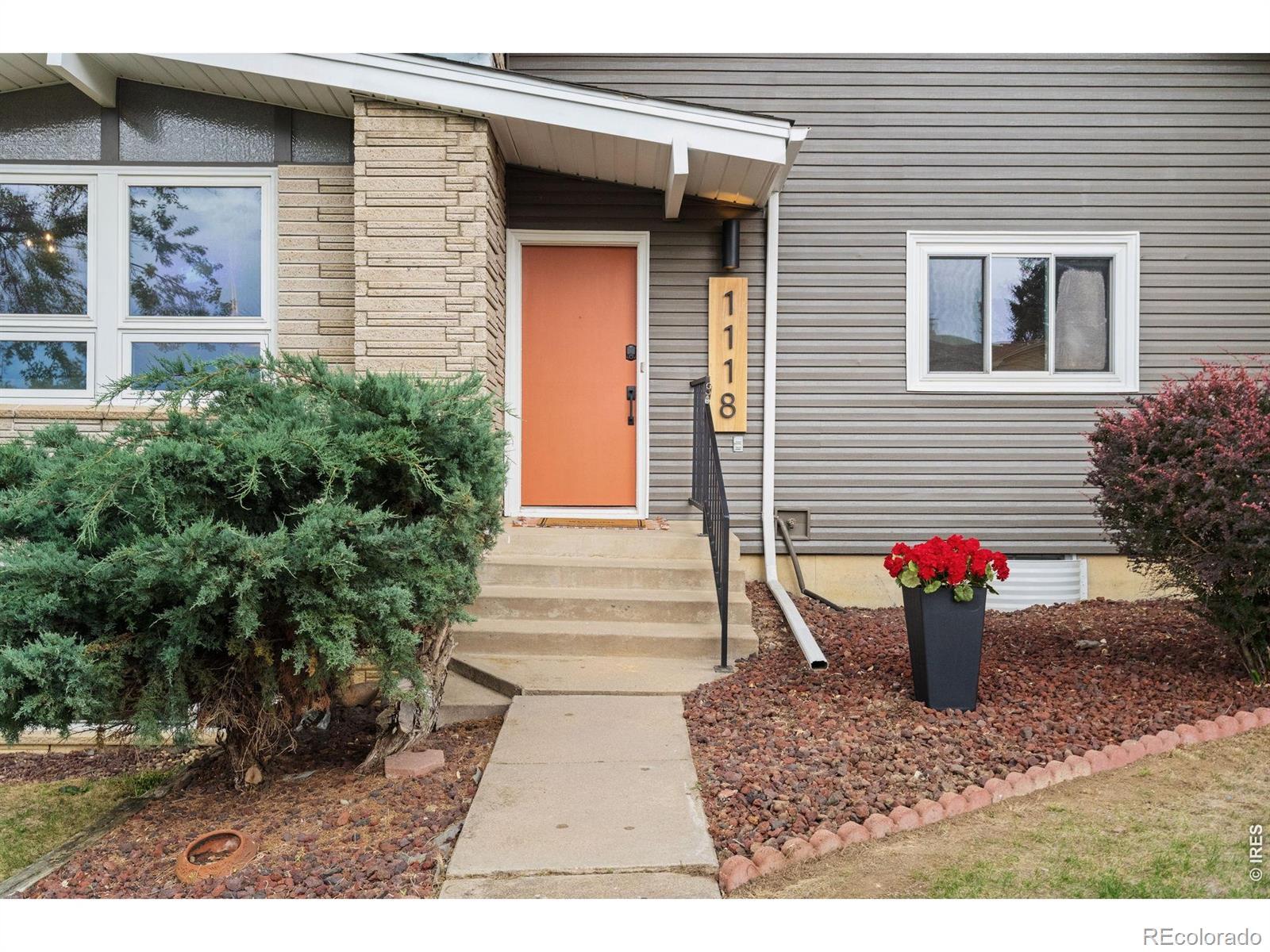 Image 4: Mosey up the front walk to be greeted by fresh exterior paint and a pop of color on the front door