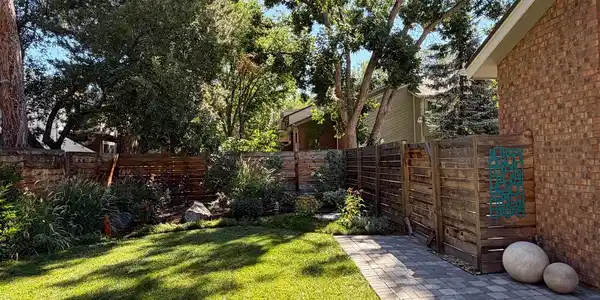 Image 4: Beautifully Landscaped yard! Entry gate on the right side of this photo to the driveway/garage Image 4: Beautifully Landscaped yard! Entry gate on the right side of this photo to the driveway/garage