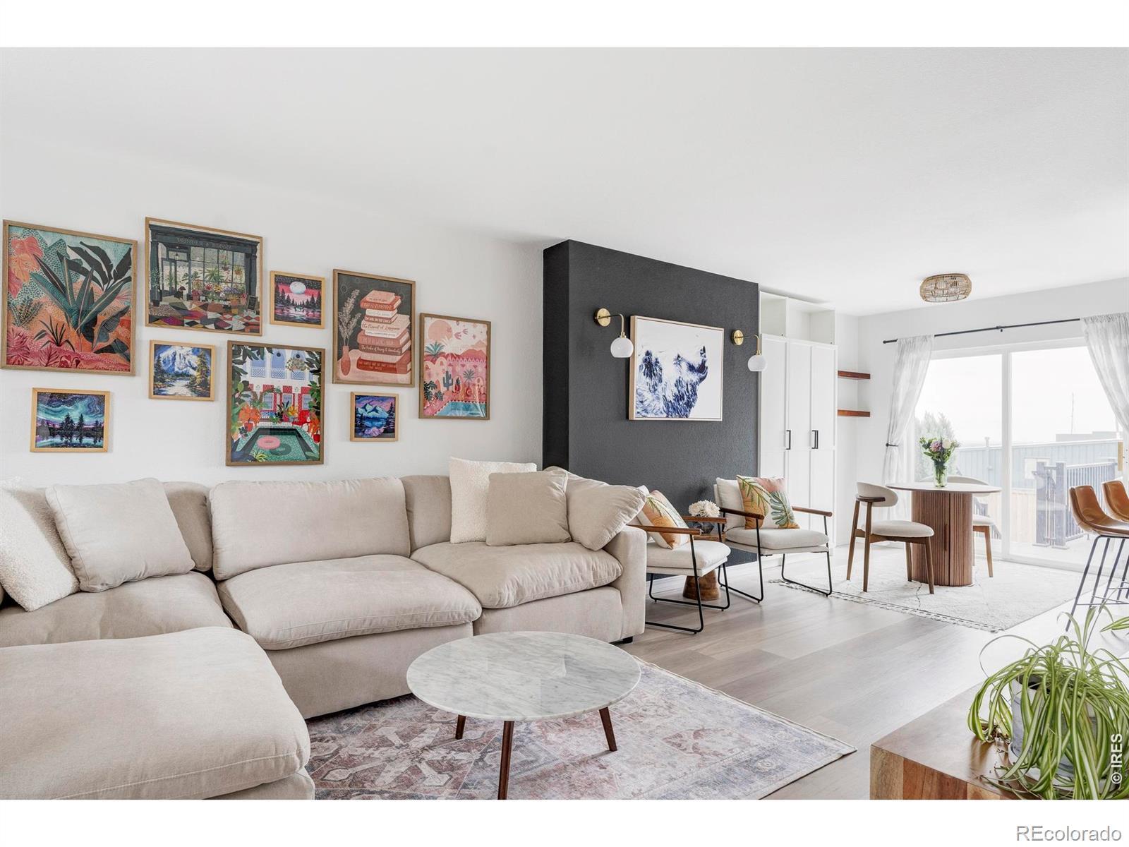Image 3: This home has been brought forward through a thoughtful remodel that introduces a clean, modern palette with updated flooring throughout, including luxury vinyl on the main level and plush carpet above and below.