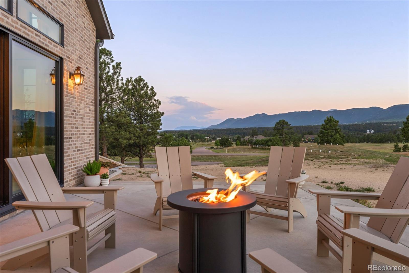 Image 4: Outdoor fire pit with breathtaking mountain views, perfect for relaxing evenings.