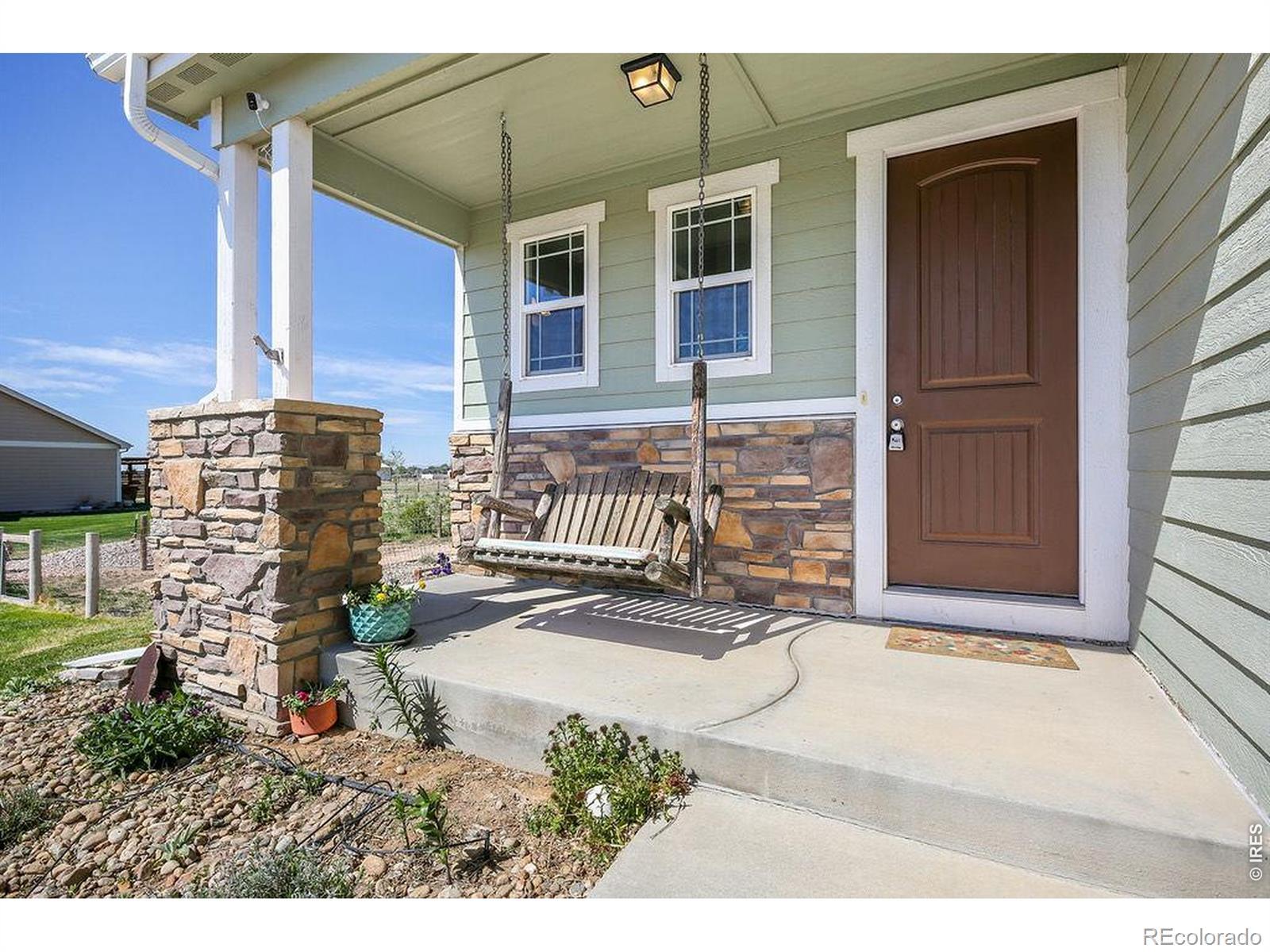 Image 2: Unwind on the inviting front porch - swing is included! Image 2: Unwind on the inviting front porch - swing is included!