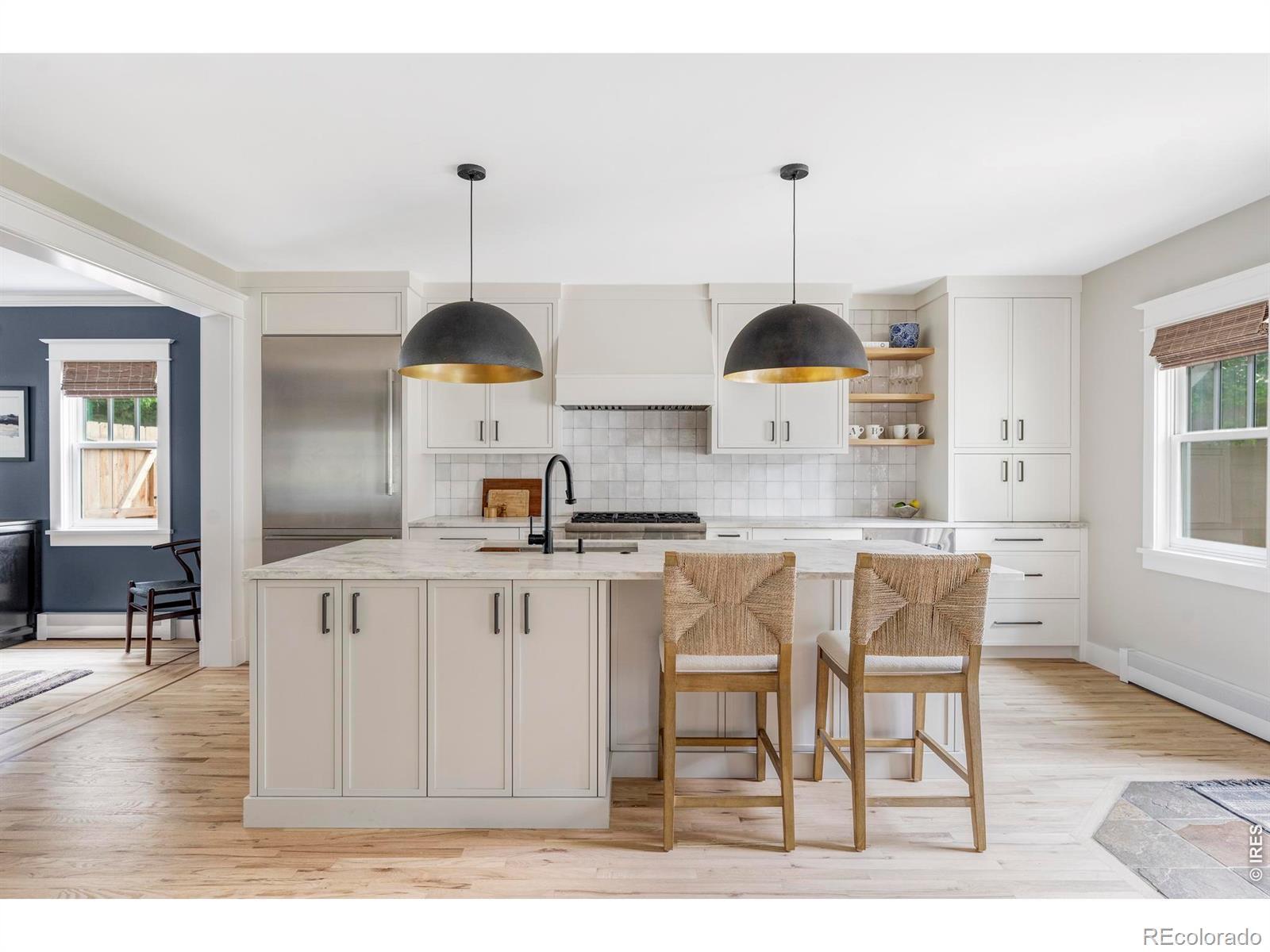 Image 2: The remodeled kitchen pairs custom cabinetry, leathered quartzite counters, and a large island designed for both prep and gathering. Image 2: The remodeled kitchen pairs custom cabinetry, leathered quartzite counters, and a large island designed for both prep and gathering.