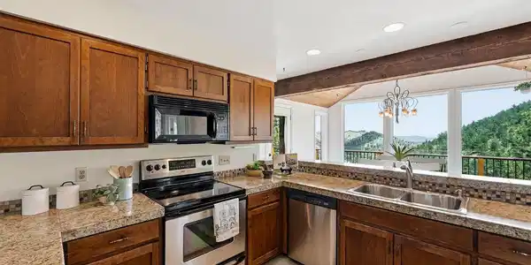 Image 4: Kitchen opens to the dining area with a wall of windows Image 4: Kitchen opens to the dining area with a wall of windows
