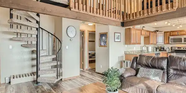 Image 2: Spiral staircase leads to loft, luxury vinyl tile wood flooring