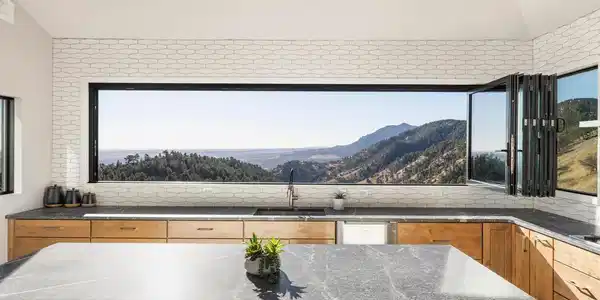 Image 2: A 16-foot pass-through window above the sink opens completely, inviting fresh mountain air and effortless connection to the expansive deck. Image 2: A 16-foot pass-through window above the sink opens completely, inviting fresh mountain air and effortless connection to the expansive deck.