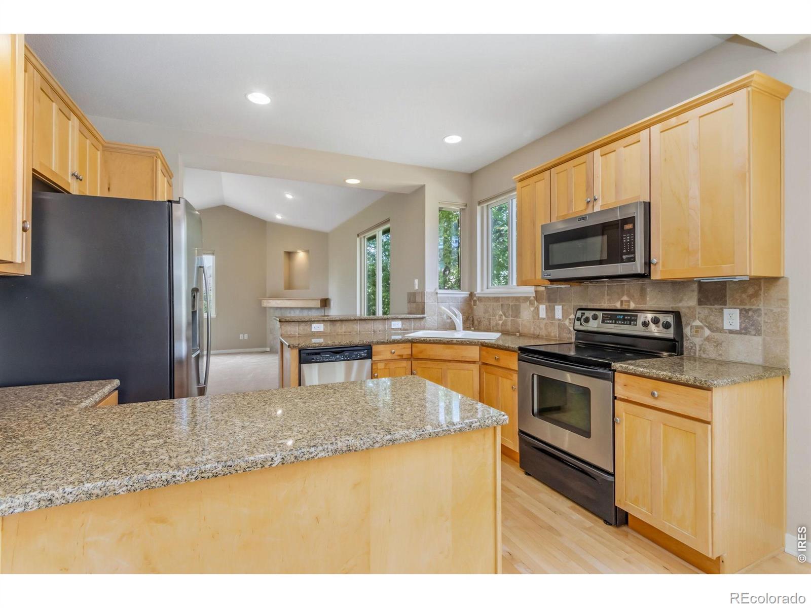 Image 3: Granite counters and maple cabinetry highlight this beautiful kitchen Image 3: Granite counters and maple cabinetry highlight this beautiful kitchen