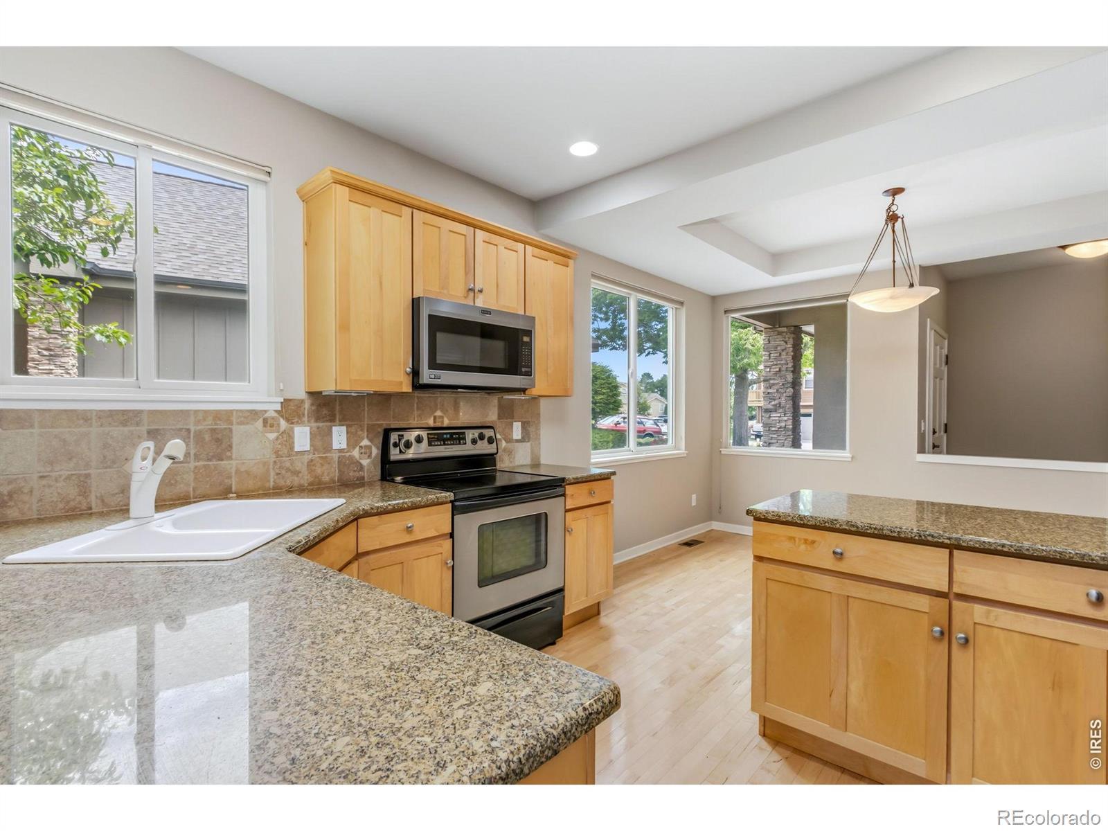 Image 4: Corner window in kitchen captures outdoor views Image 4: Corner window in kitchen captures outdoor views