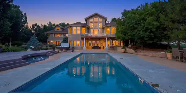 Image 2: Stunning twilight view of the pool and beautifully illuminated rear of the home. Image 2: Stunning twilight view of the pool and beautifully illuminated rear of the home.