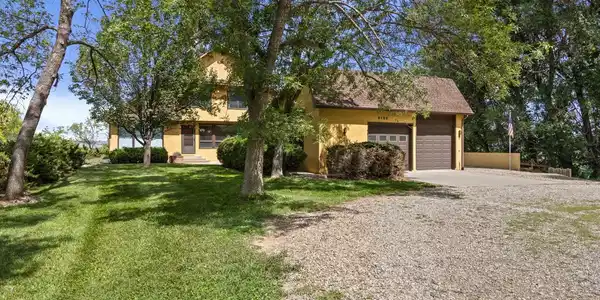 Image 2: Grand home with circular drive, oversized garage with RV bay, and lots of shade trees