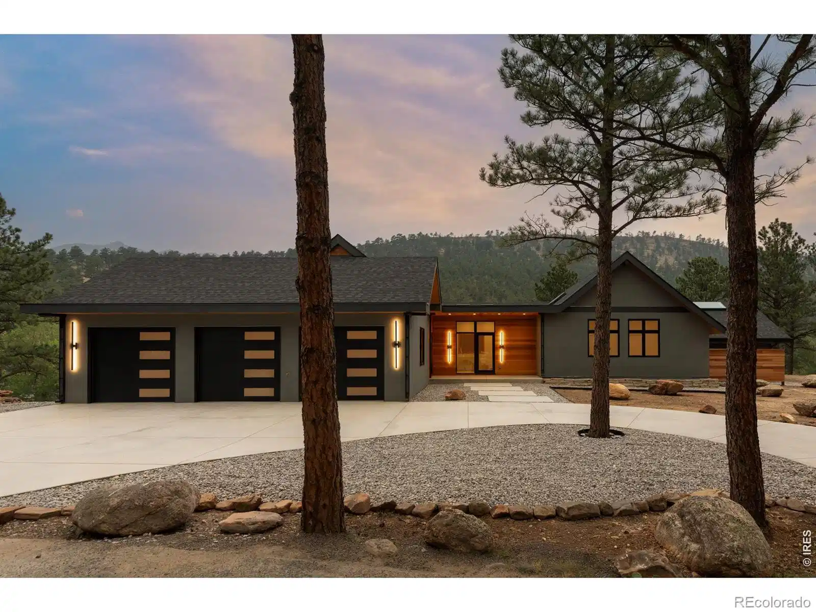 Image 1: A striking arrival framed by natural materials, clean lines, and mature pines welcomes you home. Image 1: A striking arrival framed by natural materials, clean lines, and mature pines welcomes you home.