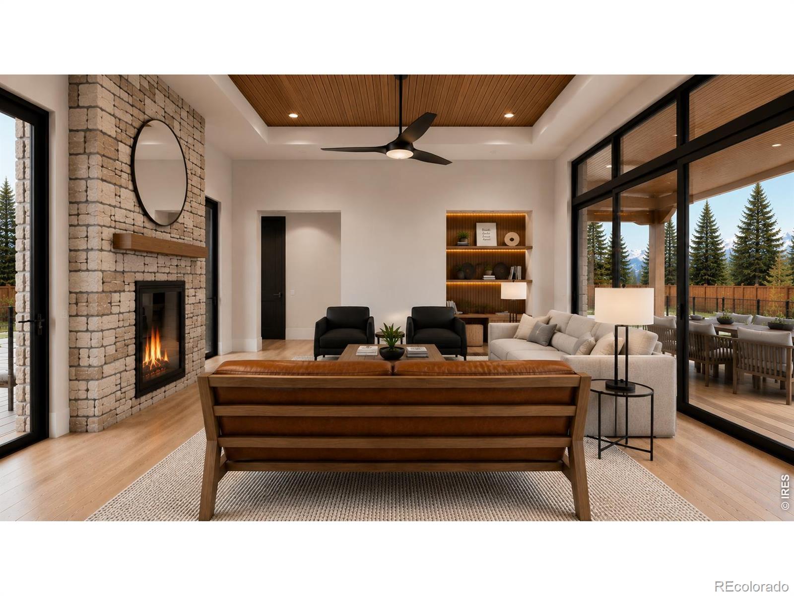 Image 4: Living room with double sided fireplace that opens to the front patio and the back patio. Image 4: Living room with double sided fireplace that opens to the front patio and the back patio.