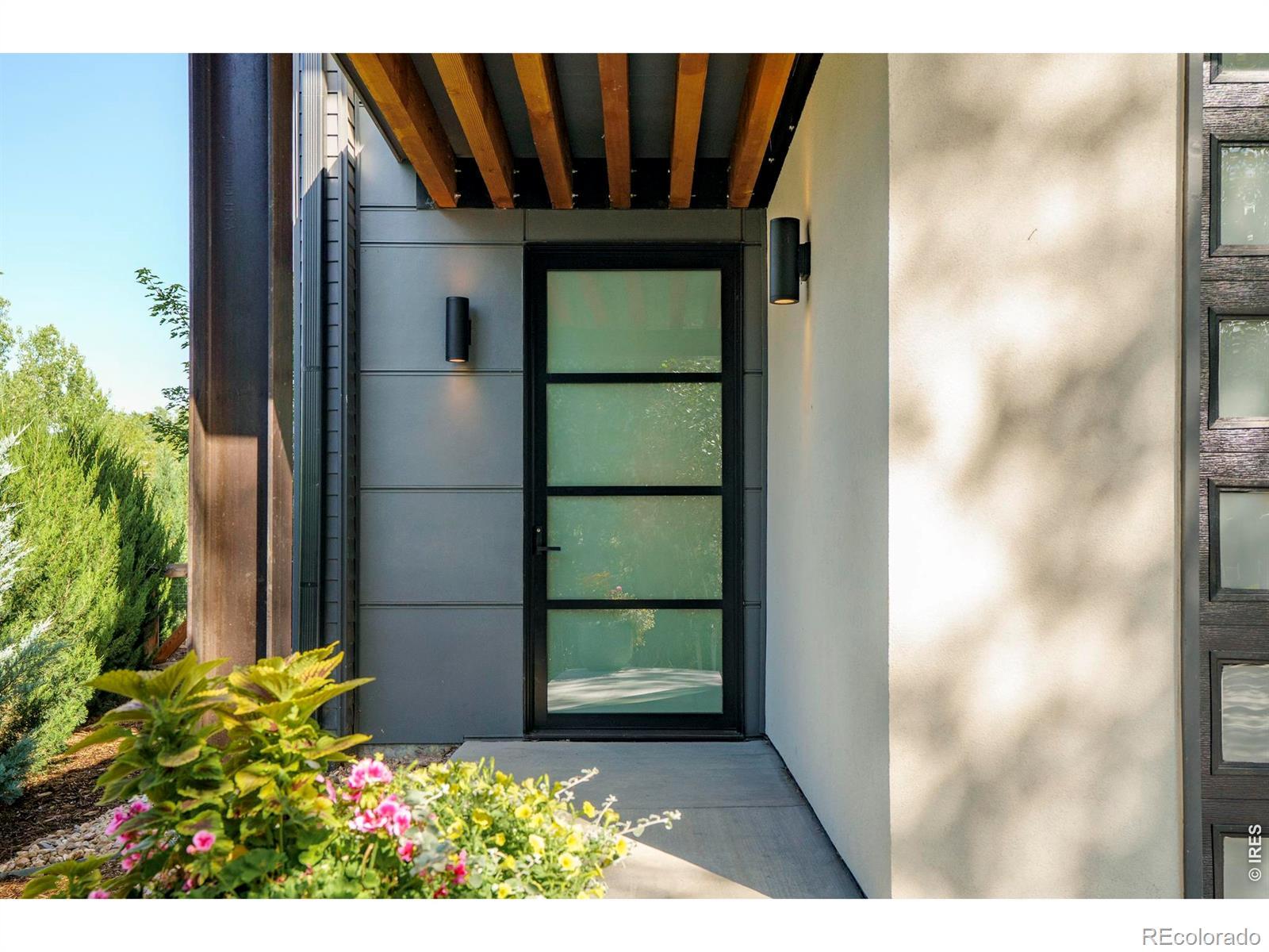 Image 2: A covered front entry introduces the homes clean modern architecture with warm wood soffits, crisp lines, and an inviting approach that reflects the thoughtful design found throughout. Image 2: A covered front entry introduces the homes clean modern architecture with warm wood soffits, crisp lines, and an inviting approach that reflects the thoughtful design found throughout.