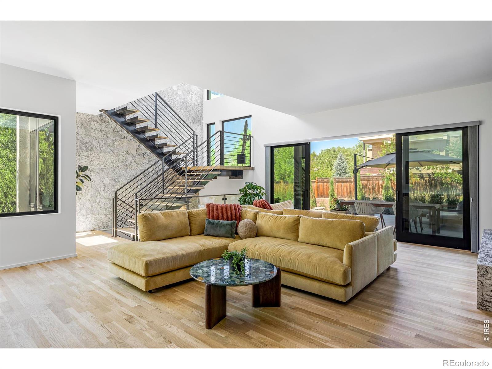 Image 4: Large sliding glass doors extend the living room outdoors, filling the space with natural light and creating an effortless connection to the covered patio and landscaped backyard. Image 4: Large sliding glass doors extend the living room outdoors, filling the space with natural light and creating an effortless connection to the covered patio and landscaped backyard.