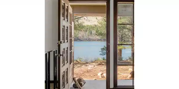 Image 2: Welcome to 2939 S Lakeridge Trail, a rare lakefront home in Boulders gated Lake of the Pines community offering direct access to Allens Lake and a setting surrounded by ponderosa pines and foothill views.