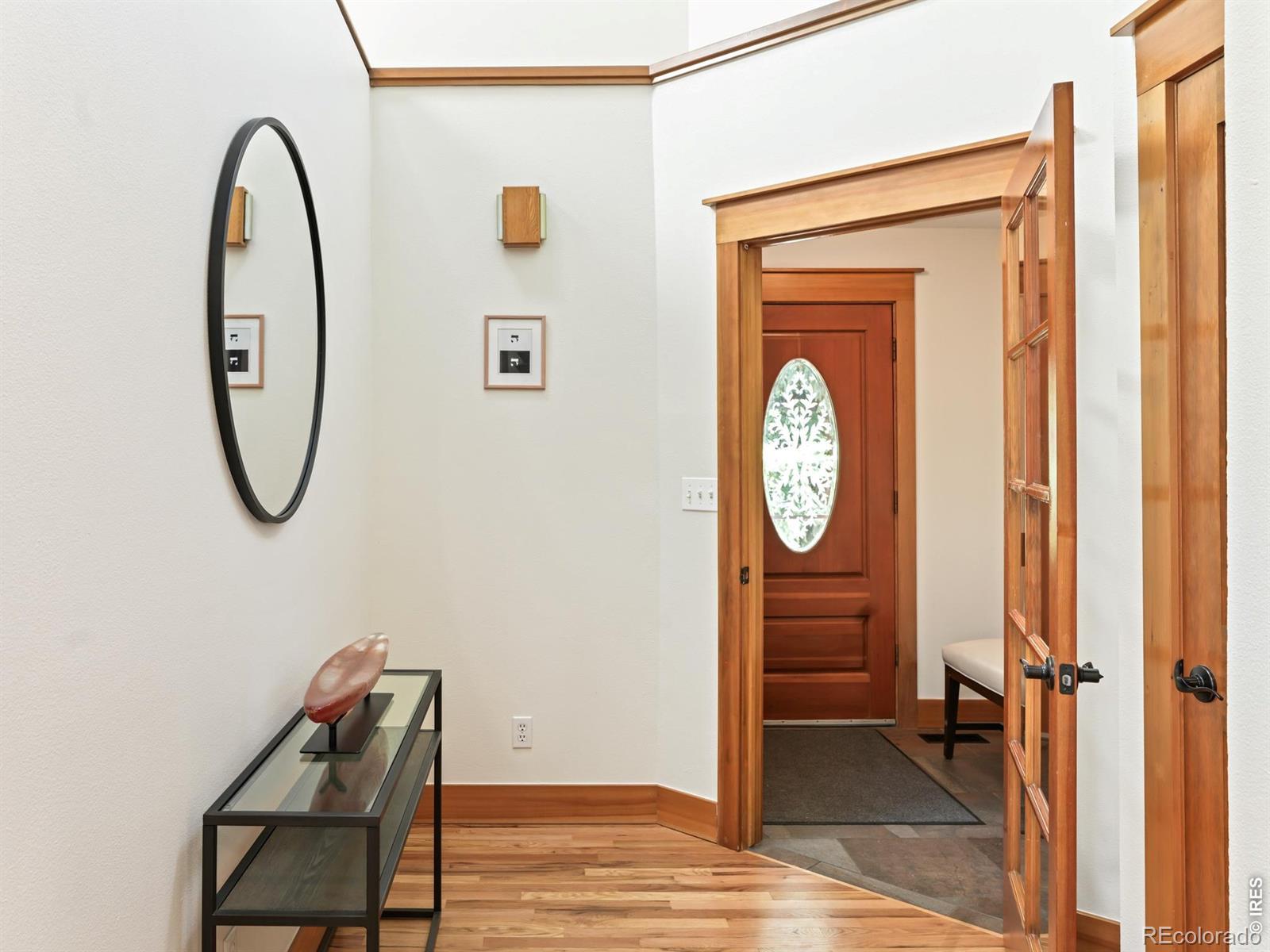 Image 3: The welcoming tiled entryway opens to a foyer with hardwood floors. Image 3: The welcoming tiled entryway opens to a foyer with hardwood floors.