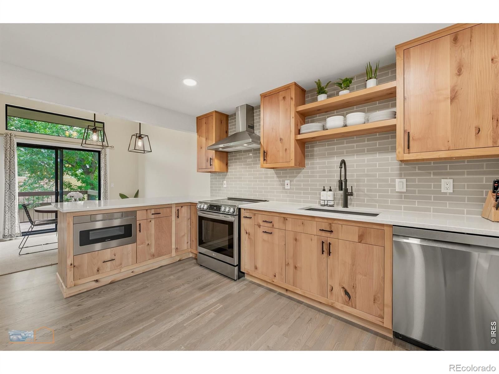 Image 2: Renovated kitchen with custom Knotty Alder cabinets, new high-end appliances, Quartz counters, and white oak hardwood floors. Image 2: Renovated kitchen with custom Knotty Alder cabinets, new high-end appliances, Quartz counters, and white oak hardwood floors.