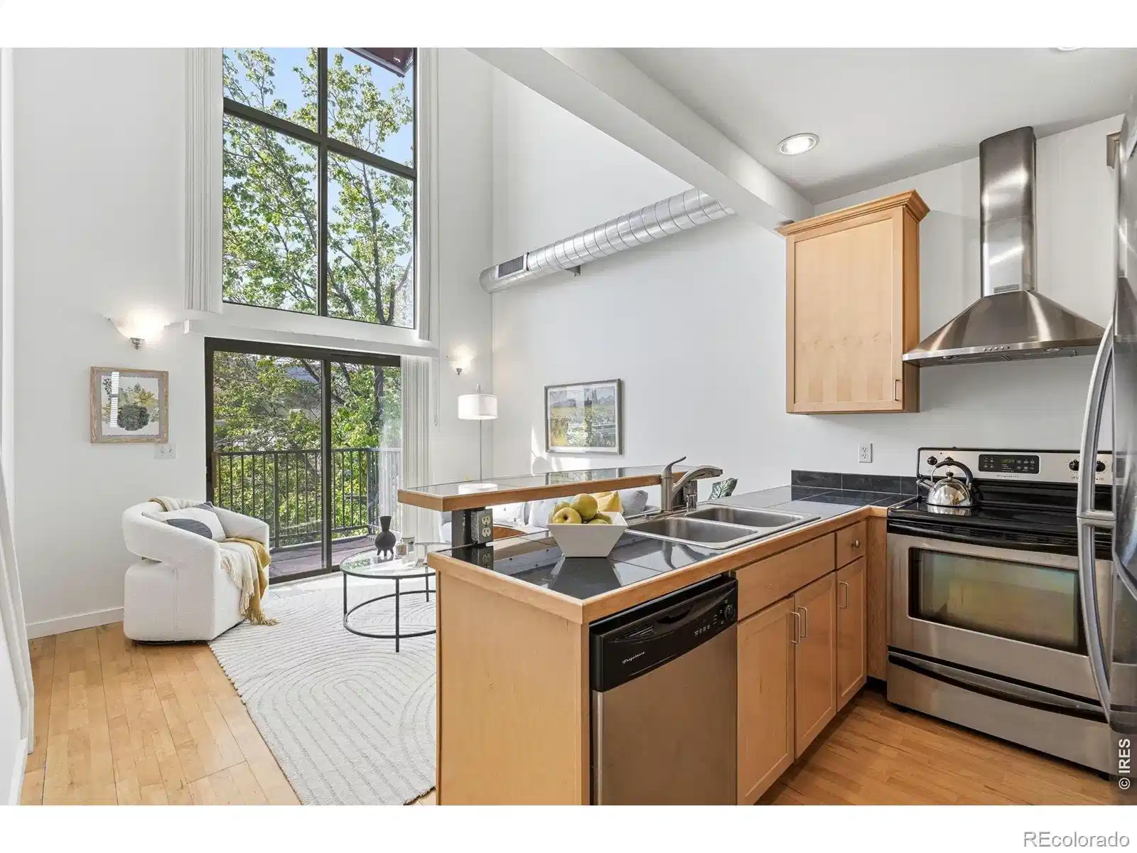 Image 1: Modern kitchen opens to the living space with 2 story windows! Image 1: Modern kitchen opens to the living space with 2 story windows!