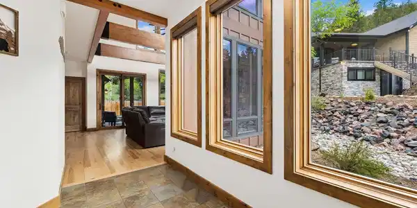 Image 3: The foyer greets you with tile floors and a peek at the beams of the great room Image 3: The foyer greets you with tile floors and a peek at the beams of the great room