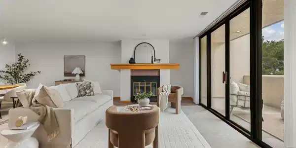 Image 4: Living area with wood-burning fireplace and spacious west-facing balcony with foothill views Image 4: Living area with wood-burning fireplace and spacious west-facing balcony with foothill views