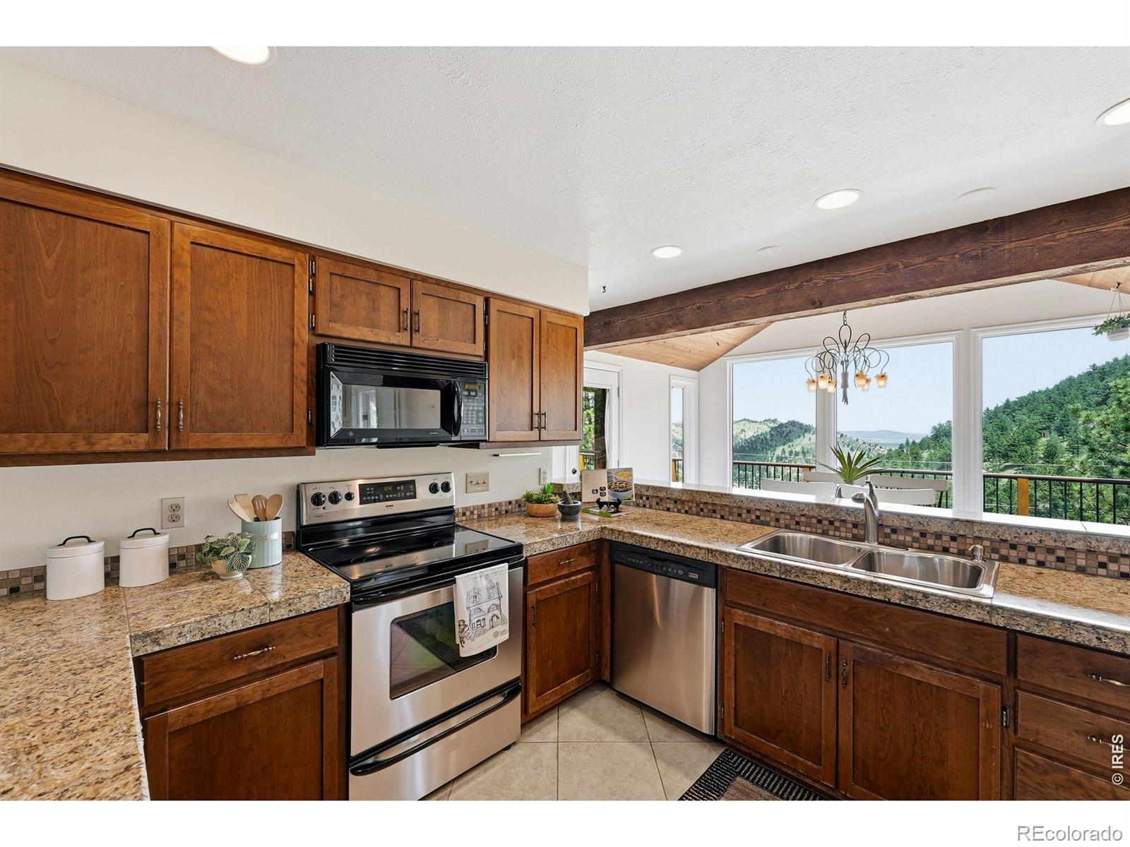 Image 4: Kitchen opens to the dining area with a wall of windows Image 4: Kitchen opens to the dining area with a wall of windows