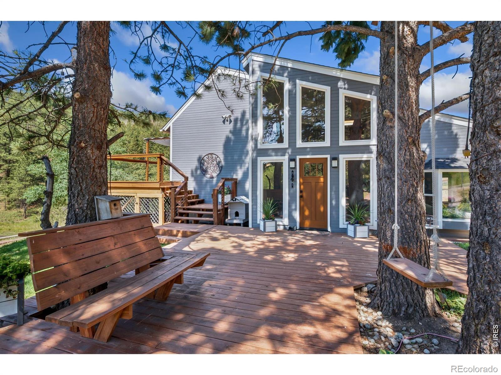 Image 3: Front of home, mostly south facing with large, double pane windows, newer decking and mature landscaping. Sit on a swing or bench and enjoy everything this property has to offer. Image 3: Front of home, mostly south facing with large, double pane windows, newer decking and mature landscaping. Sit on a swing or bench and enjoy everything this property has to offer.