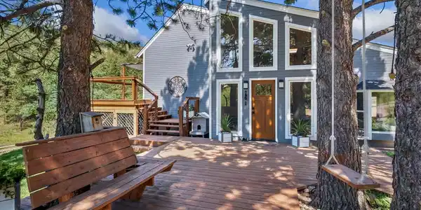 Image 3: Front of home, mostly south facing with large, double pane windows, newer decking and mature landscaping. Sit on a swing or bench and enjoy everything this property has to offer. Image 3: Front of home, mostly south facing with large, double pane windows, newer decking and mature landscaping. Sit on a swing or bench and enjoy everything this property has to offer.