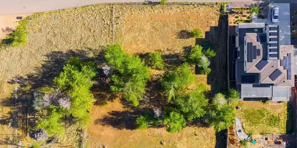 Image 2: This level lot provides flexibility for either a larger single-family residence or two smaller single-family homes, with existing city water and sewer connections already in place.