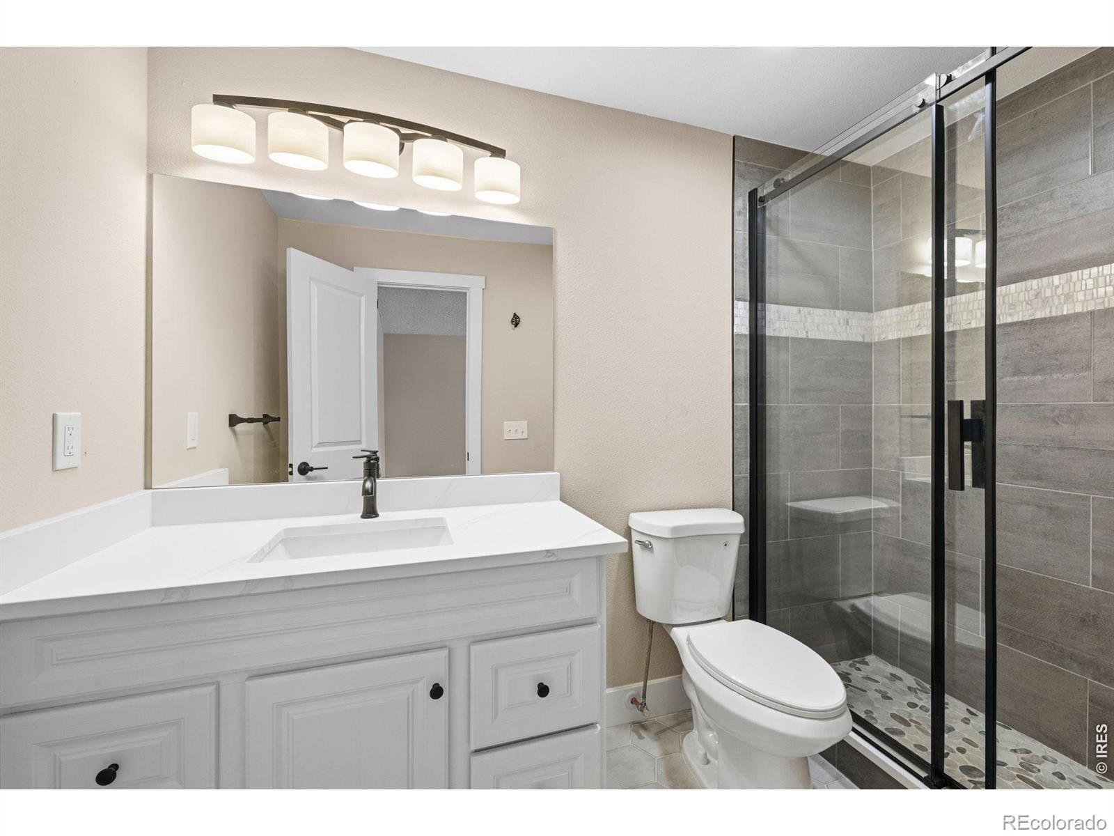 Image 4: 2026 renovated bathroom with floor to ceiling tiled custom shower with extra tall barn door style glass doors Image 4: 2026 renovated bathroom with floor to ceiling tiled custom shower with extra tall barn door style glass doors
