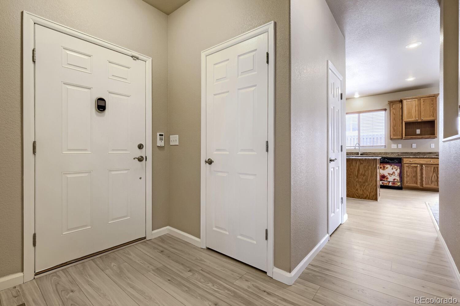 Image 3: interior shot of front door and coat closet, kitchen down the hall Image 3: interior shot of front door and coat closet, kitchen down the hall
