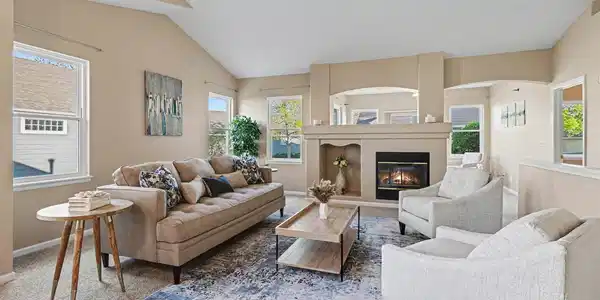 Image 3: Cozy living room featuring a warm fireplace, large windows for natural light, and elegant vaulted ceilings. Image 3: Cozy living room featuring a warm fireplace, large windows for natural light, and elegant vaulted ceilings.