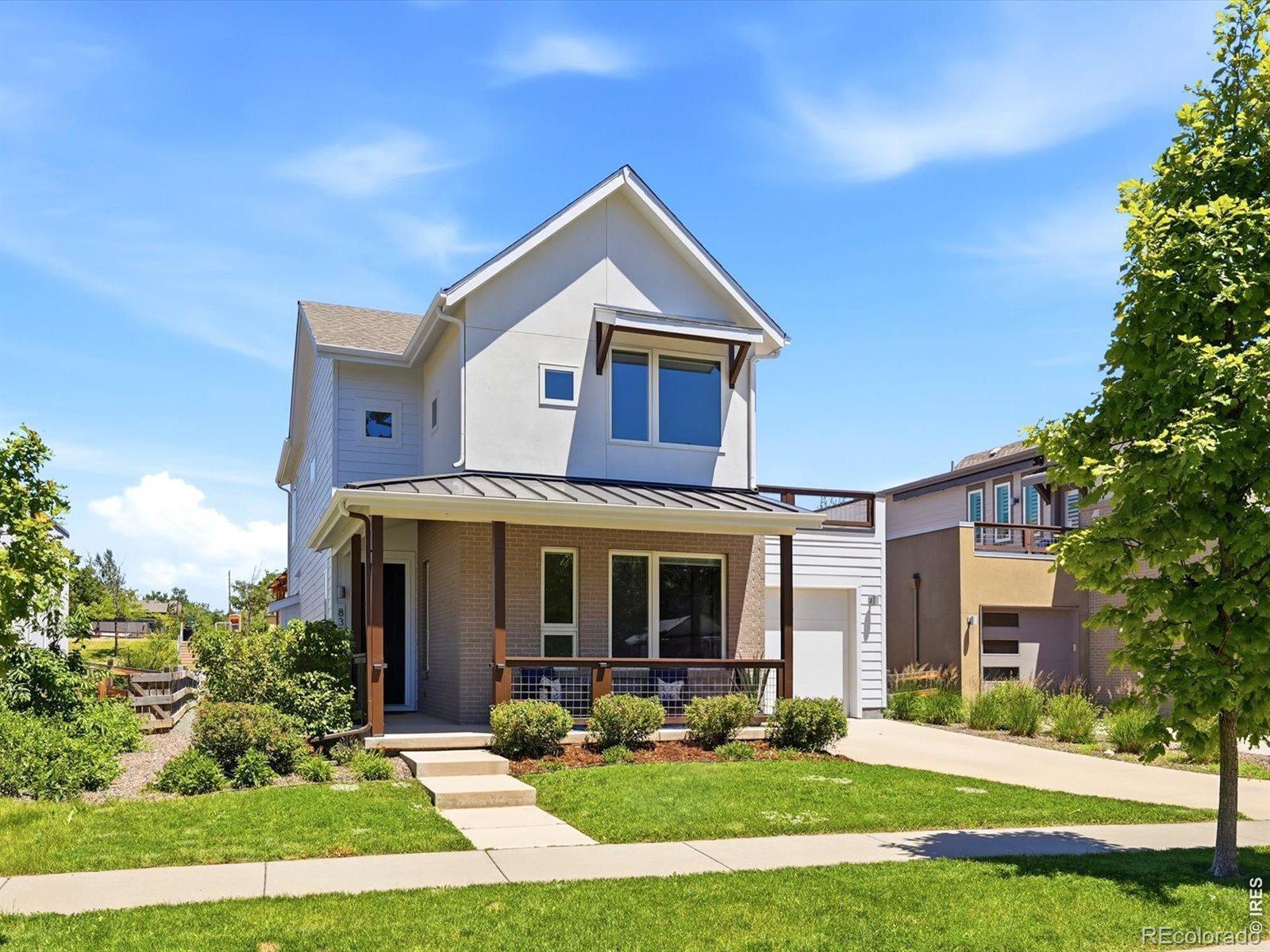 Image 2: Freshly painted, south-facing home with clean architectural lines and covered front porch.