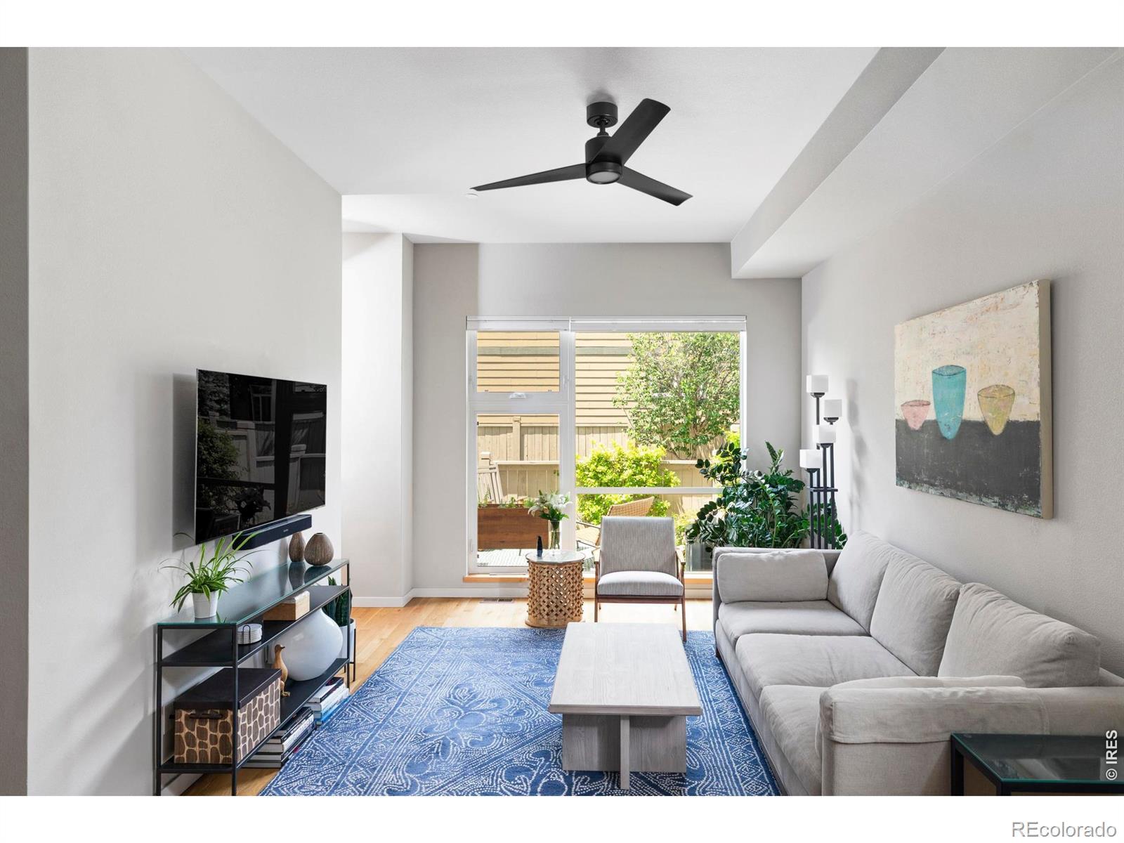 Image 2: Ten-foot ceilings, walls of windows, and hardwood floors run throughout, with recessed and designer lighting thoughtfully placed.