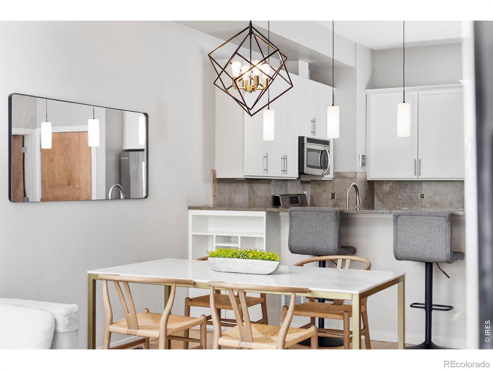Image 4: The kitchen, dining, and living areas share the main floor in an open configuration that works well for both everyday use and hosting.