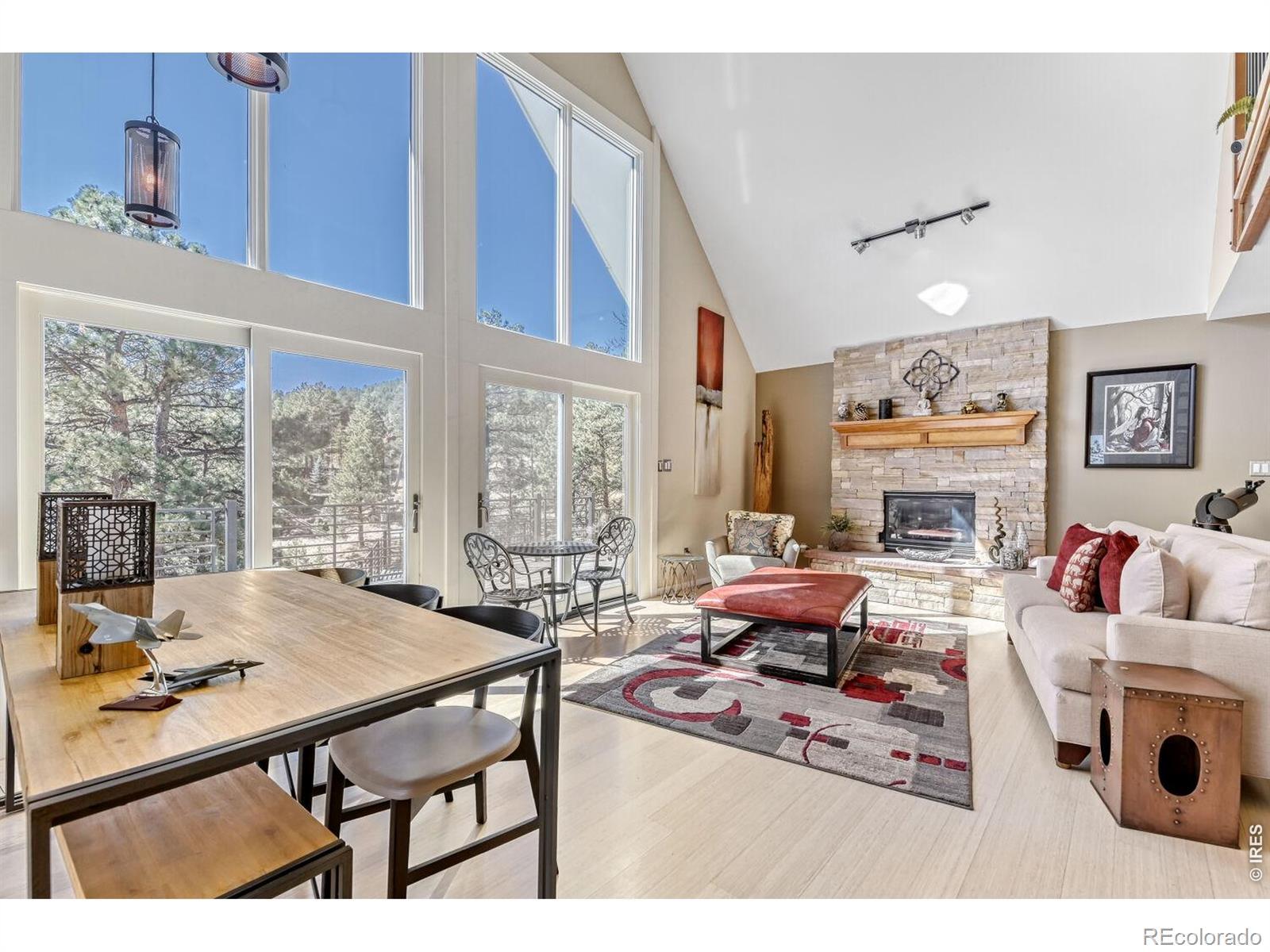 Image 3: Living room features wood flooring, fireplace and views