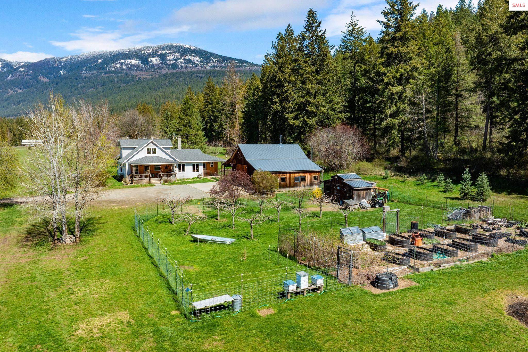Image 4: There is a house, shop with bonus rooms, chicken coop, orchard, garden, pasture, & alfalfa field