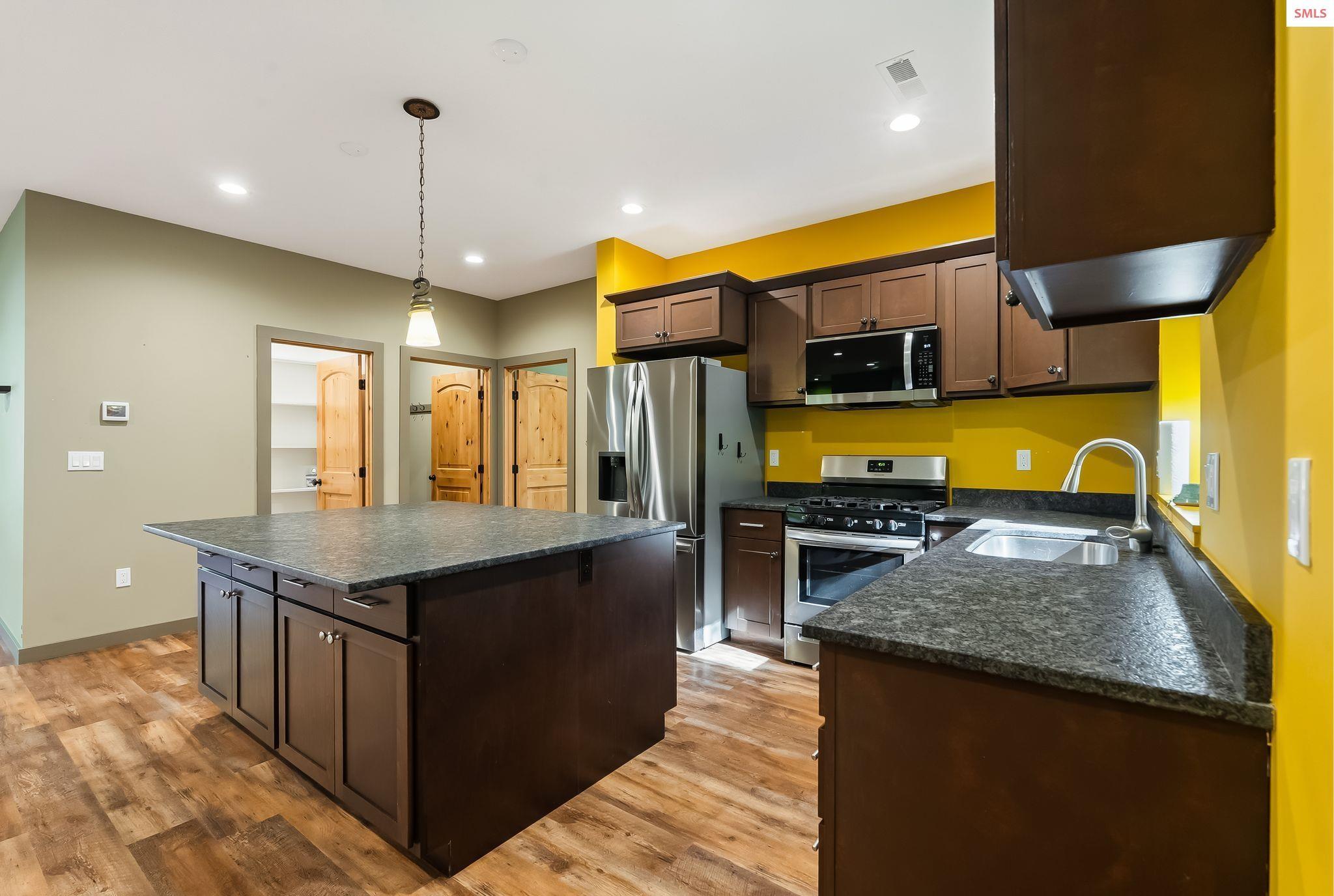 Image 4: Kitchen with large island, lots of storage, granite countertops and stainless steel appliances
