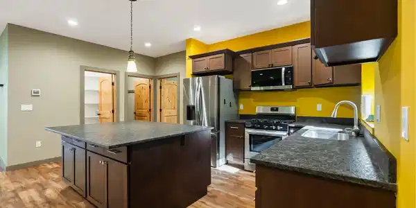 Image 4: Kitchen with large island, lots of storage, granite countertops and stainless steel appliances