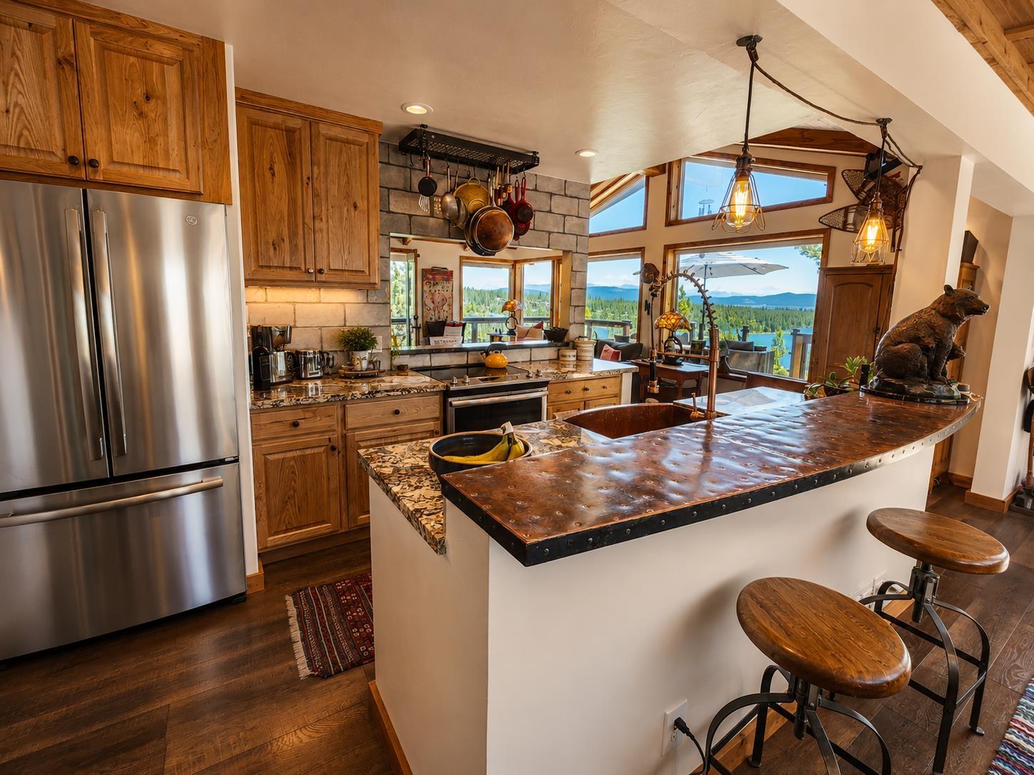 Image 4: Granite Counters, stainless appliances, deep copper sink, pantry.