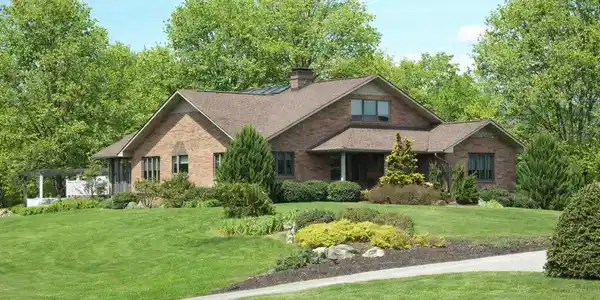Image 2: Suburban home with vibrant landscaping