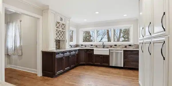 Image 4: Beautiful Windows allowing sunlight to fill the kitchen! Built-in cabinetry provides substantial storage for all your kitchen gadgets and supplies.