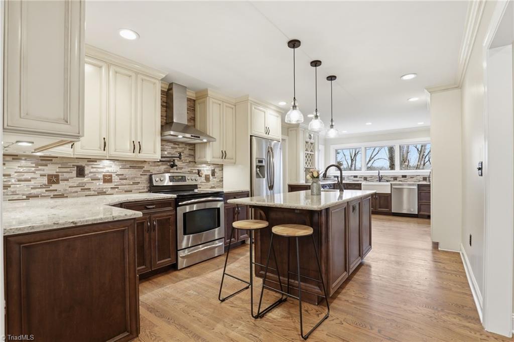 Image 2: Chef's Kitchen! TONS of counterspace, pot filler over stove top, prep sink in island plus farmhouse sink with beautiful backyard view! Plenty of space for friends and family to gather.